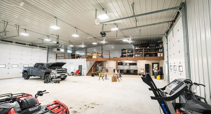 the inside of a garage with several vehicles in it