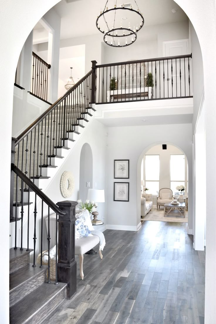 the inside of a house with stairs and wood floors