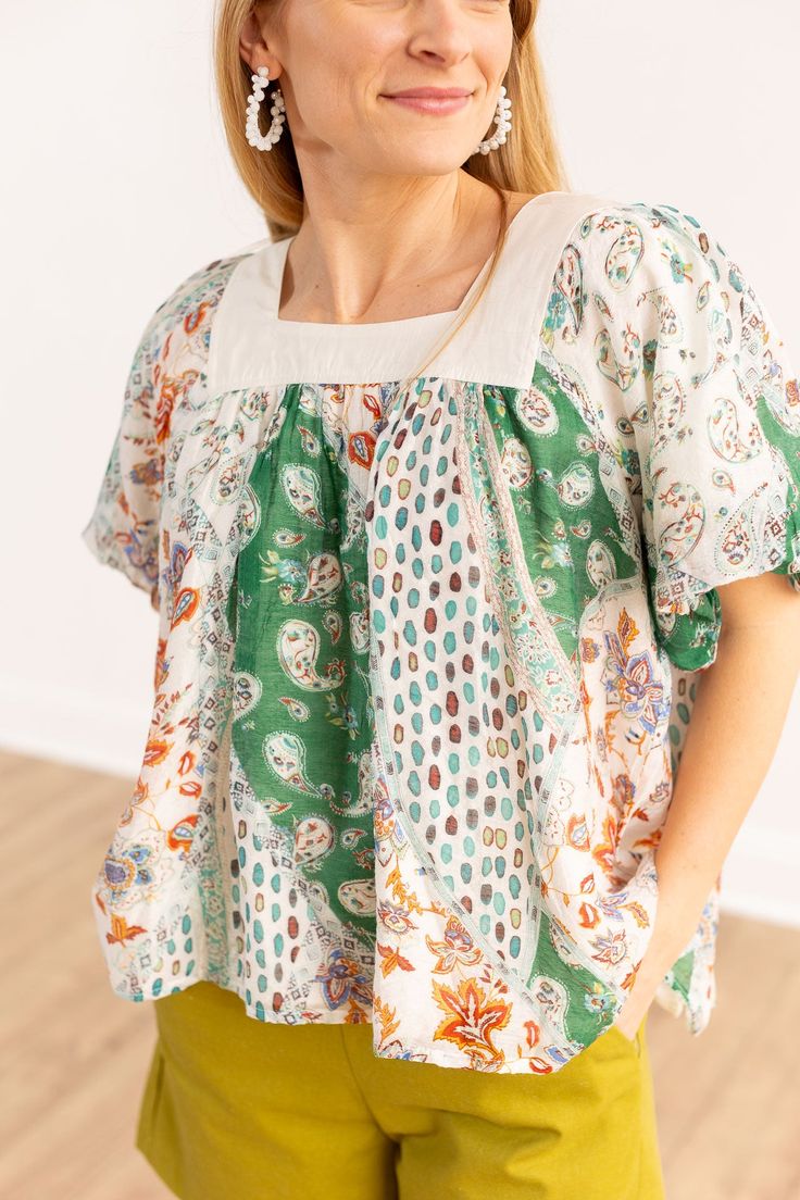 The Rosemary top is the epitome of bohemian romanticism. The multi-print fabric makes this the perfect piece for when you want to add a splash of color to your look. Embrace the warm summer hues with your new go-to top. Material: 100% RayonFit: Relaxed, TTSOur model is wearing a size small Bohemian Short Sleeve Peasant Top For Day Out, White Floral Print Hippie Top, Spring Hippie Patterned Top, Free-spirited Tops For Spring Vacation, Green Bohemian Top For Day Out, Hippie Patterned Spring Top, Hippie Patterned Tops For Spring, Bohemian Multicolor Print Blouse For Beach, Bohemian Multicolor Print Beach Blouse