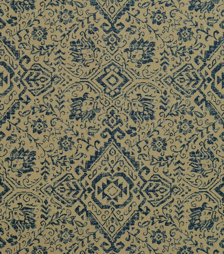 an area rug with blue and beige designs on it