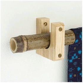 a pair of wooden pegs mounted to a wall next to a blue curtain rod