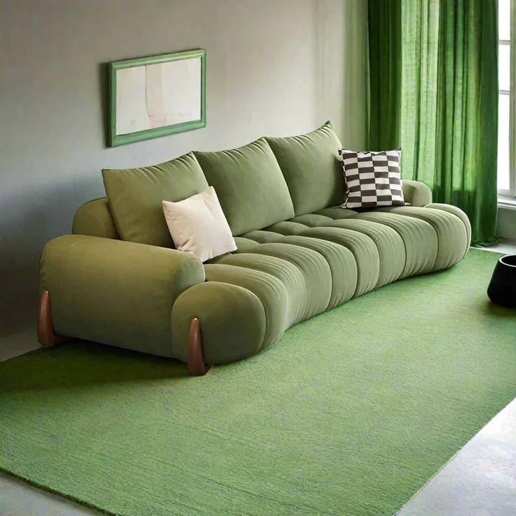 a living room with green curtains and a couch in the middle, on top of a rug