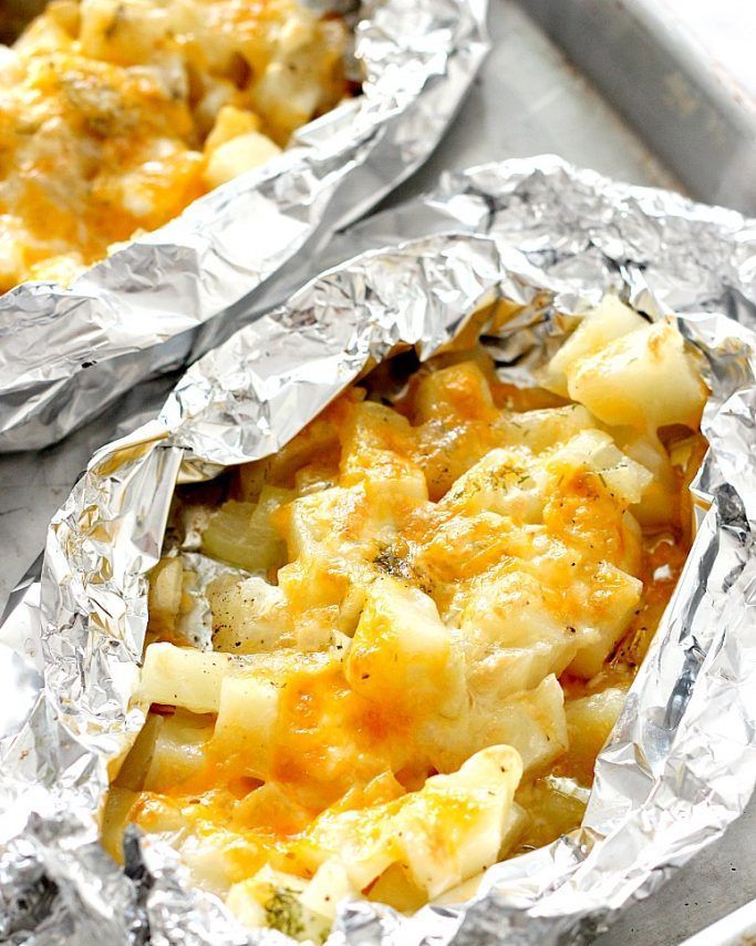 two foil packets filled with food sitting on top of a table