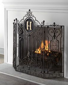 an iron fireplace screen with the letter h on it's front and back sides