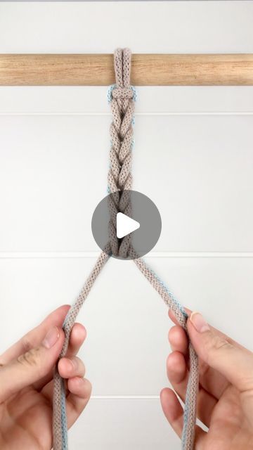 two hands are pulling the end of a rope