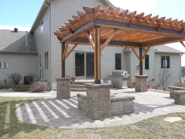 an outdoor patio with seating and grill area