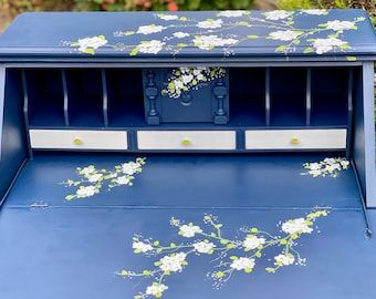 a blue desk with white flowers on it