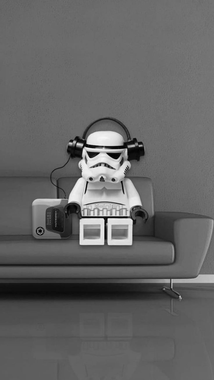 a lego storm trooper sitting on top of a couch with headphones in his ears