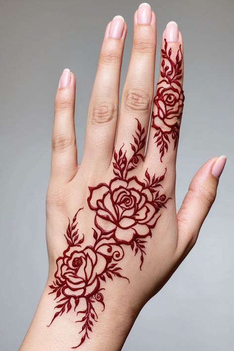 a woman's hand with hendix on it and flowers painted on the palm