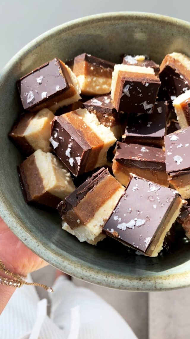 a bowl filled with pieces of chocolate and marshmallows