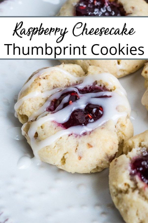 raspberry cheesecake thumbprint cookies on a white plate with the words, raspberry cheesecake thumbprint cookies