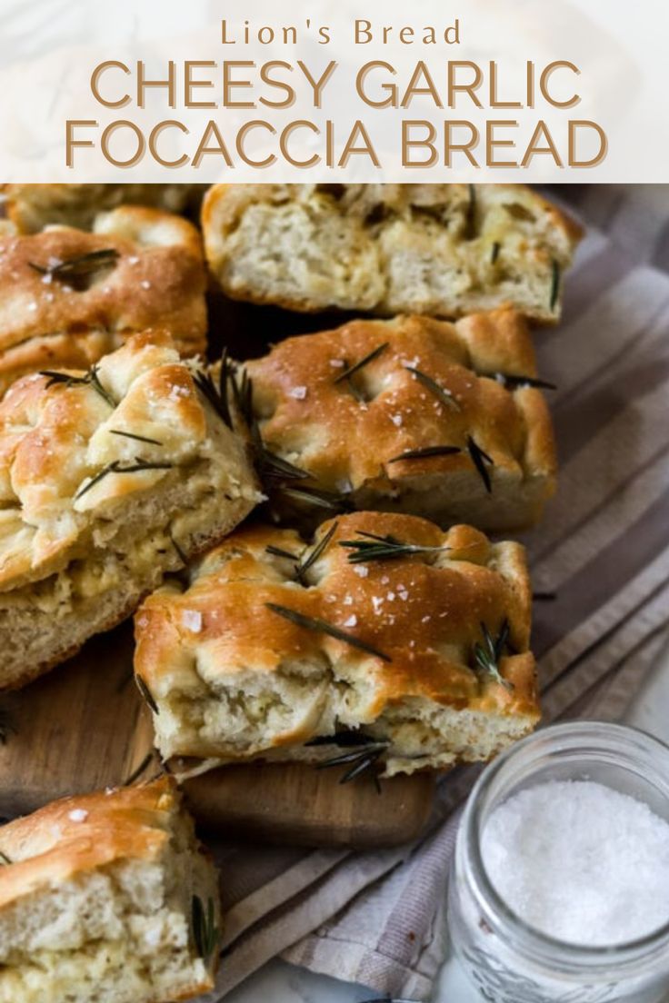 Sliced cheesy garlic rosemary focaccia bread on a wooden cutting board with flaky sea salt on the side with the words "Lion's bread cheesy garlic focaccia bread" in the foreground Herb And Cheese Focaccia, Garlic Foccia Bread, Parmesan Herb Focaccia, Rosemary And Garlic Foccacia Bread, Cheese Focaccia Bread Recipe, Garlic Onion Foccacia, Rosemary Garlic Sourdough Foccacia, Focaccia Bread Cheese, Mozzarella Focaccia Bread