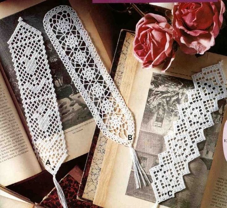 an open book with lace and flowers on it, next to a pair of scissors