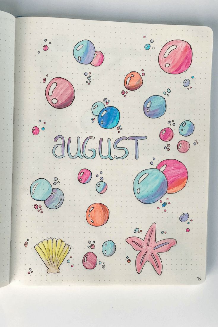 an open notebook with the words august written on it and drawings of sea animals, seashells, and stars