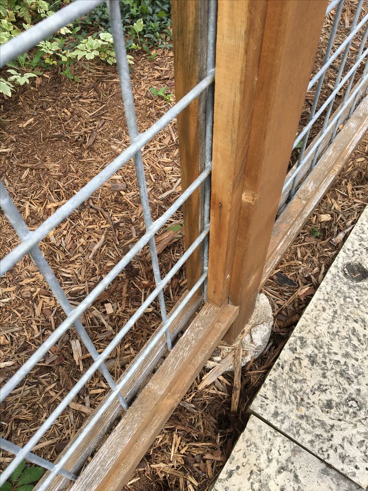 a close up of a metal and wood fence