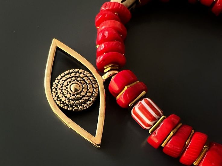 The Red Coral Evil Eye Bracelet displays a unique vibrant style and has immense spiritual and protective power. Featuring red coral stones and a large evil eye charm this bracelet is stylish and powerful to wear during meditation and daily life. The Evil Eye is a prominent symbol in Turkish and many other cultures, and is highly protective. Evil Eye is also called nazar. Evil Eye beads reflect ill intent and jealousy from the 'evil eye' back to the person thinking of it, hence protecting the wea Traditional Red Bracelets For Meditation, Artisan Red Coral Beads For Gifts, Artisan Red Coral Beads Gift, Red Spiritual Beaded Bracelets With Natural Stones, Spiritual Red Beaded Bracelets With Natural Stones, Red Gemstone Beads Bracelets For Meditation, Gift Red Coral Bracelet With Gemstone Beads, Red Beaded Bracelets With Natural Stones For Meditation, Spiritual Red Coral Gemstone Beads