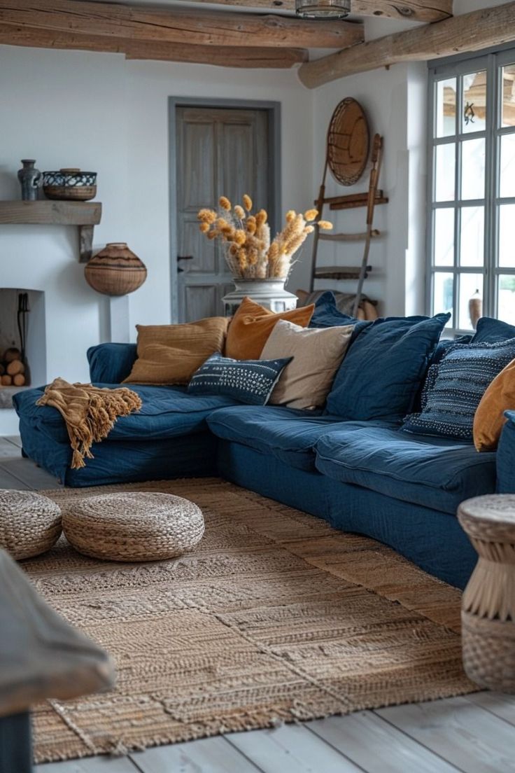 a living room filled with blue couches and pillows