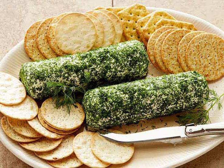 a white plate topped with sliced up vegetables and crackers