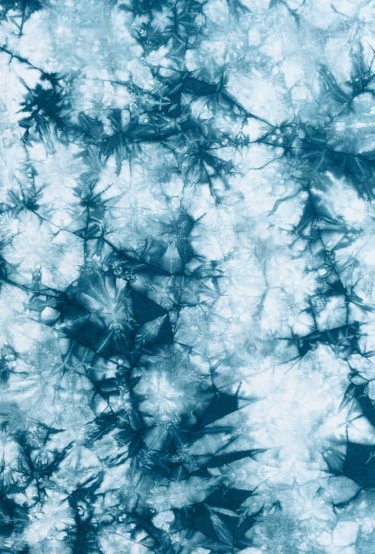 blue and white tie - dyed fabric that looks like something out of space