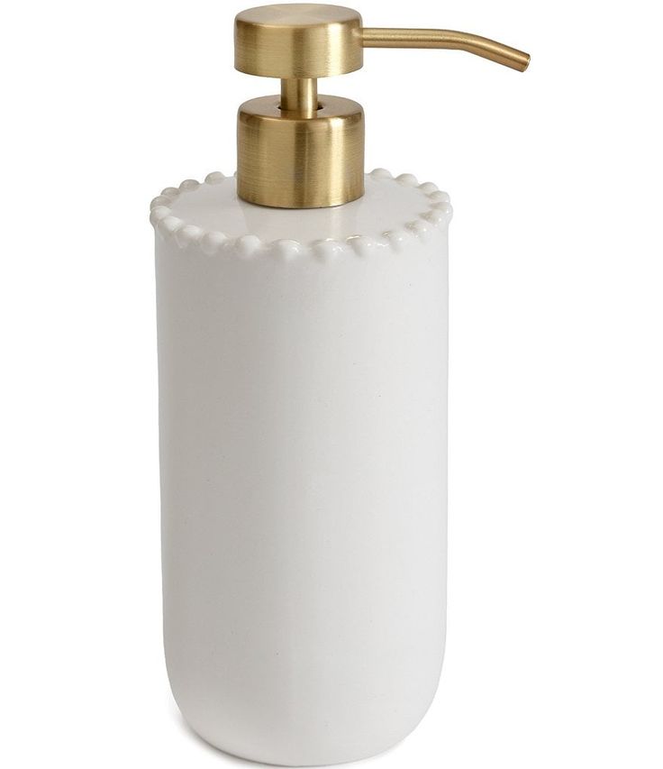 a white soap dispenser with gold accents