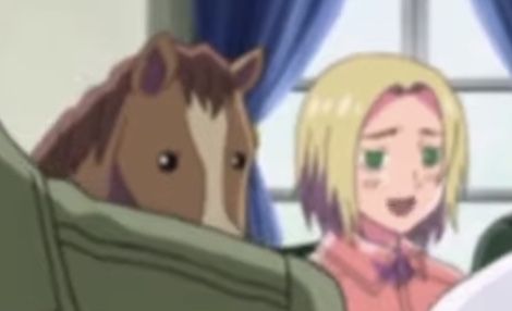 a woman sitting in a chair next to a horse and another person with blonde hair