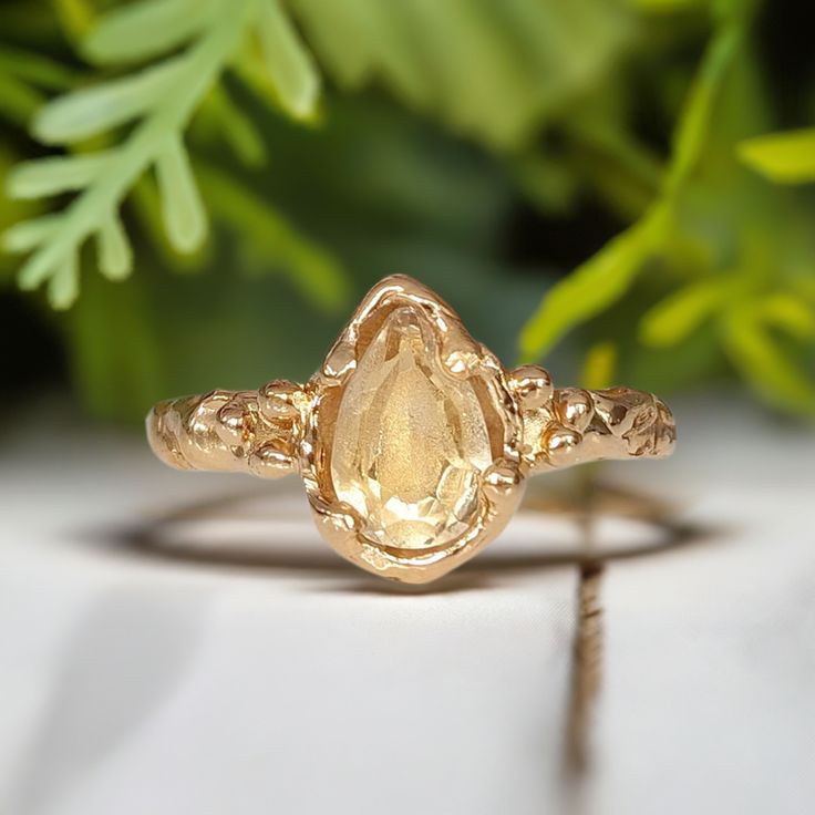 Show your love with this stunning Citrine ring - handcrafted in wax and cast in Solid 14k Gold, its organic molten band exudes natural charm. This one-of-a-kind engagement ring features a stunning pear shape yellow crystal as the November birthstone - in celebration of love's eternal bond.T H E ∙ S M A L L ∙ D E T A I L S• Pear shape faceted Citrine (8-10mm)• Solid 14k Gold textured bandM A T E R I A L ∙ O P T I O N S• Sterling Silver• Solid 14k GoldYou will receive a ring very similar to the on Yellow Stone Engagement Ring, Amber Engagement Ring, Citrine Engagement Ring, Ametrine Ring, Citrine Ring Engagement, Yellow Diamond Engagement Ring, Nature Inspired Rings, Yellow Diamond Rings, Yellow Engagement Rings