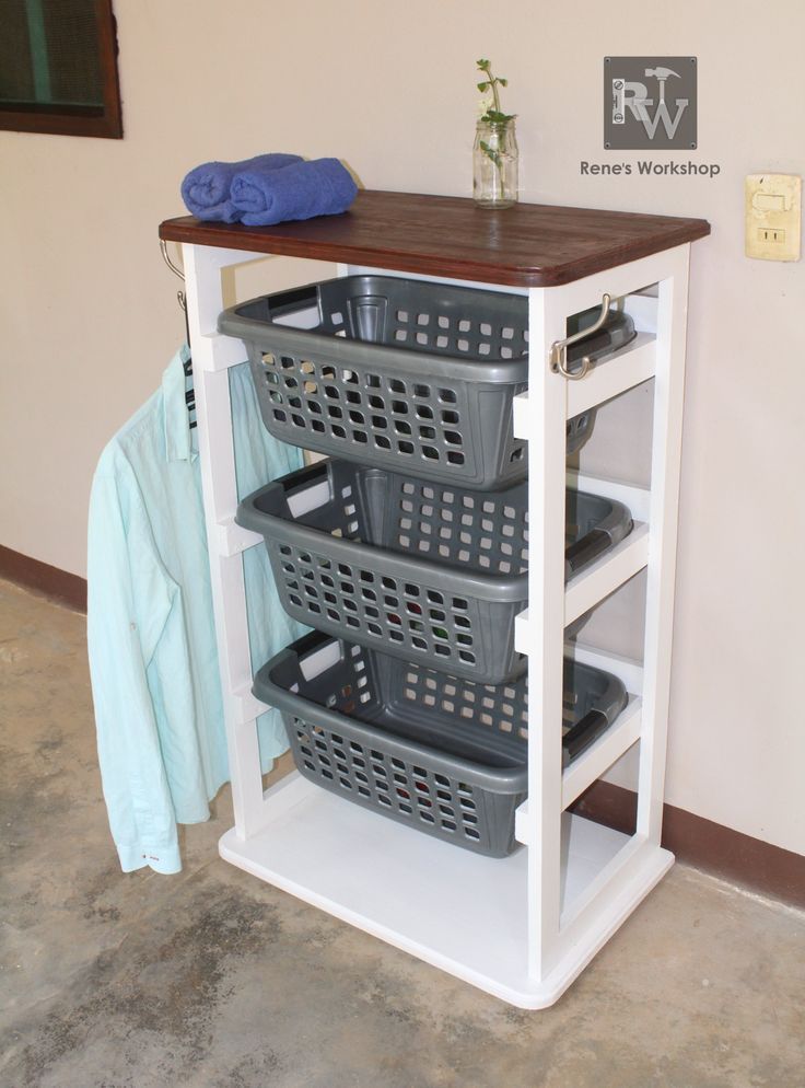 a white shelf with baskets on top of it