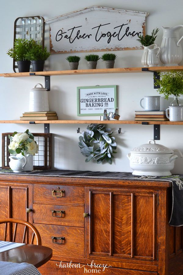 a wooden dresser topped with potted plants