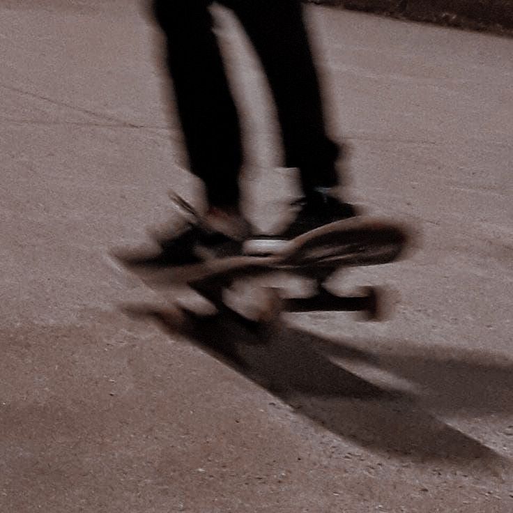 a person riding a skateboard on top of cement