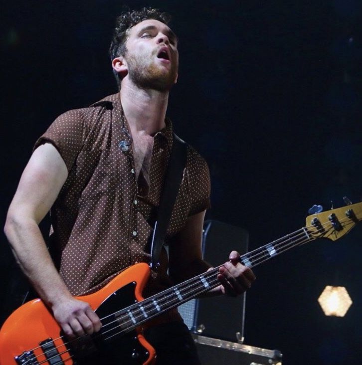 a man playing an electric guitar on stage