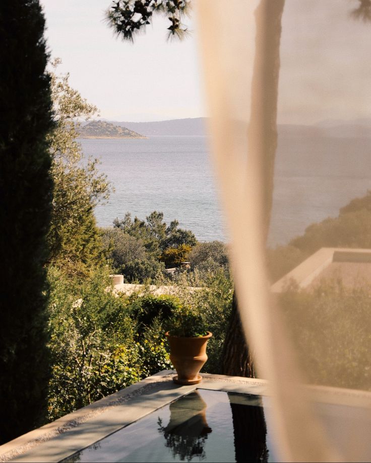 an outdoor table with a view of the ocean