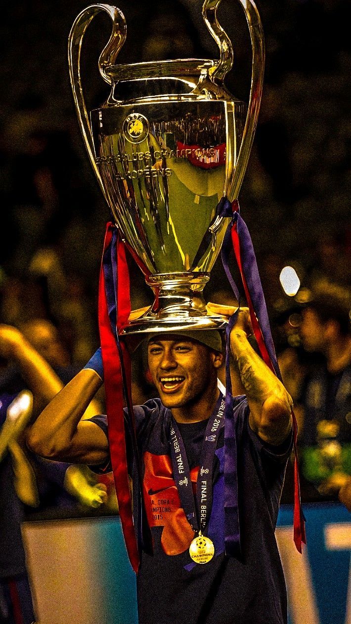 a man holding up a trophy in front of his face