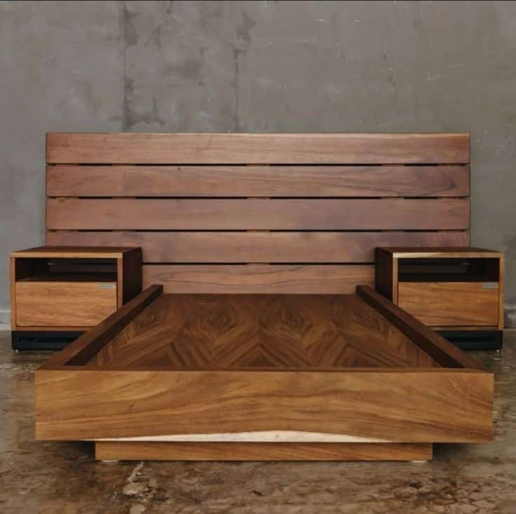 a bed made out of wood with two nightstands on each side and one end