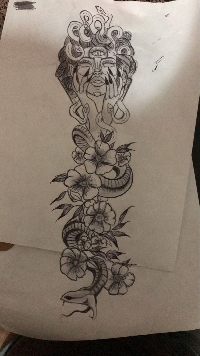 a drawing of a snake and flowers on paper