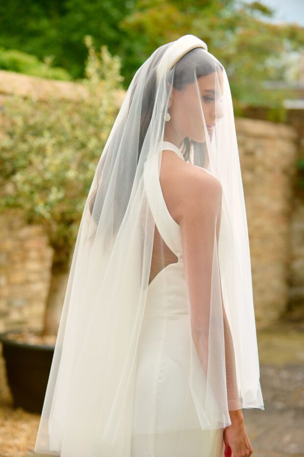 a woman in a wedding dress with a veil on her head