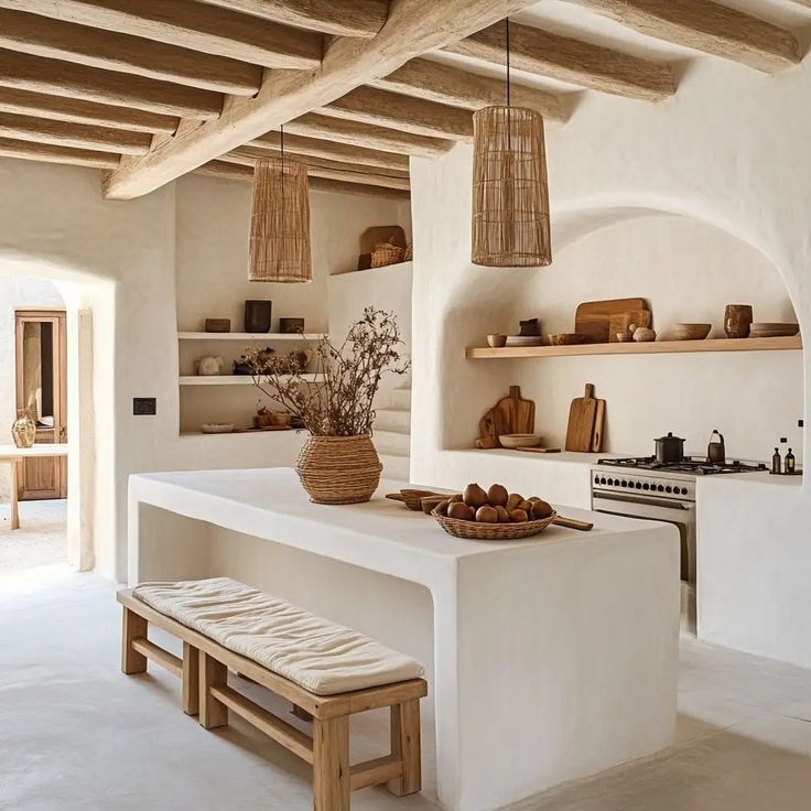 a kitchen with white walls and wooden ceilinging, an island bench is in the middle of the room