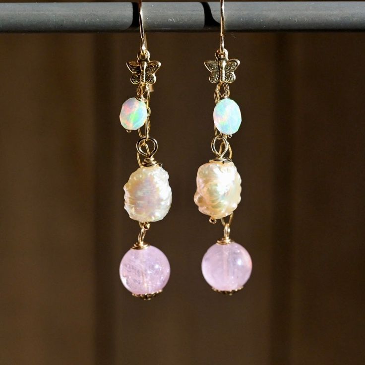 Experience the elegance and whimsy of our Butterfly Pink Dangle Earrings. Featuring soft, natural gemstones in stunning shades of pink and a luxurious 14K gold fill, these earrings make a bold statement. With a length of 2 1/2 inches, they effortlessly capture attention while also exuding a playful charm. A must-have staple for any wardrobe! Gemstones: 🔸Opals 🔹Morganite Rounds 🔸Pink Freshwater Pearls Metals: ♦️14K Gold Fill ♦️14K Gold Filled Butterfly Length: ♦️2 1/2” 14k Gold-filled Yellow Gold Earrings With Natural Stones, Pink Dainty 14k Gold Filled Earrings, Pink Briolette Earrings With Natural Stones, Pink Briolette Natural Stone Earrings, Elegant Gold Jewelry With Pink Opal, Gold Pink Opal Jewelry For Wedding, Elegant Pink Opal Yellow Gold Jewelry, Handmade Elegant Pink Opal Jewelry, Elegant Handmade Pink Opal Jewelry