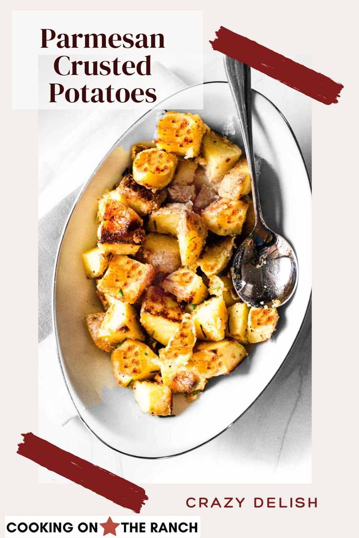 a white plate topped with cooked potatoes on top of a table next to a fork