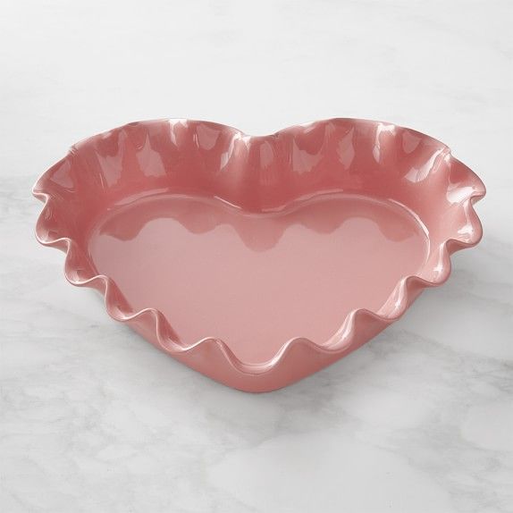 a pink heart shaped dish on a marble surface