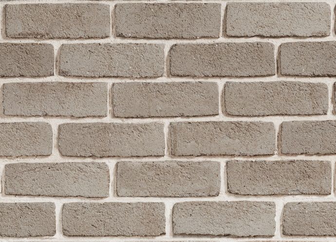 a brick wall that is made out of grey bricks