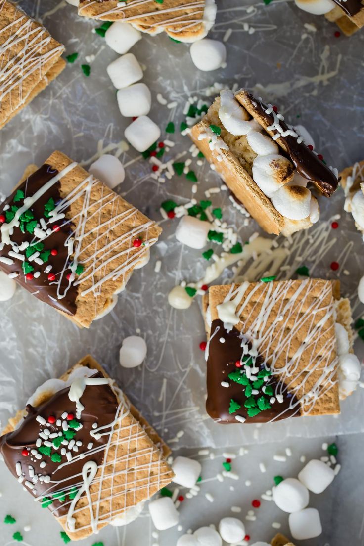 there are many desserts on the table with white and green sprinkles