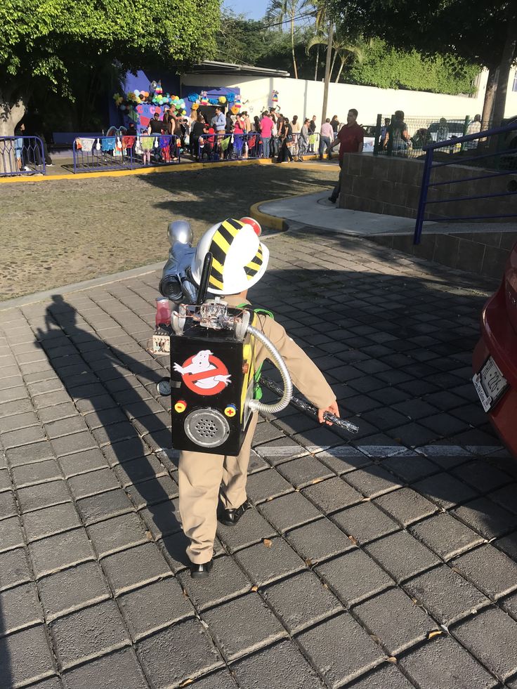 a little boy in a bee costume holding onto a parking meter