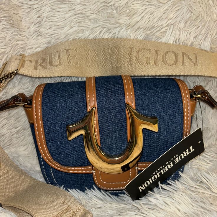 True Religion Bag Brand New Trendy Brown Bag With Branded Hardware, Trendy Brown Shoulder Bag With Branded Hardware, Brown Flap Bags With Branded Hardware, Casual Leather Bags With Branded Hardware, Trendy Brown Satchel With Branded Hardware, Casual Beige Bag With Branded Hardware, Casual Satchel With Branded Hardware For Daily Use, Casual Satchel With Branded Hardware For Shopping, Casual Rectangular Shoulder Bag With Branded Hardware