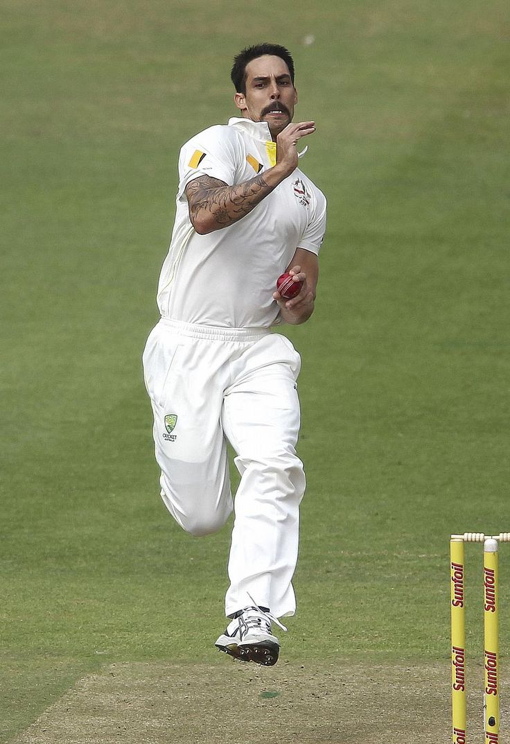 a man in white playing a game of cricket