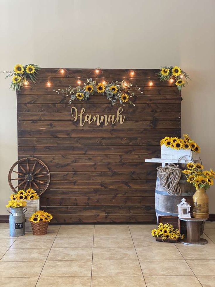 a wooden sign with sunflowers and lights on it