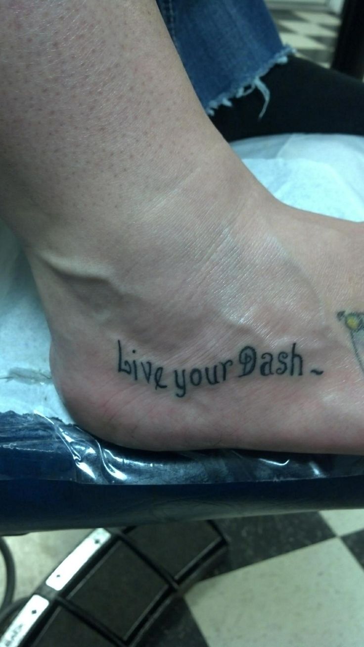 a person with a tattoo on their foot saying live your dash