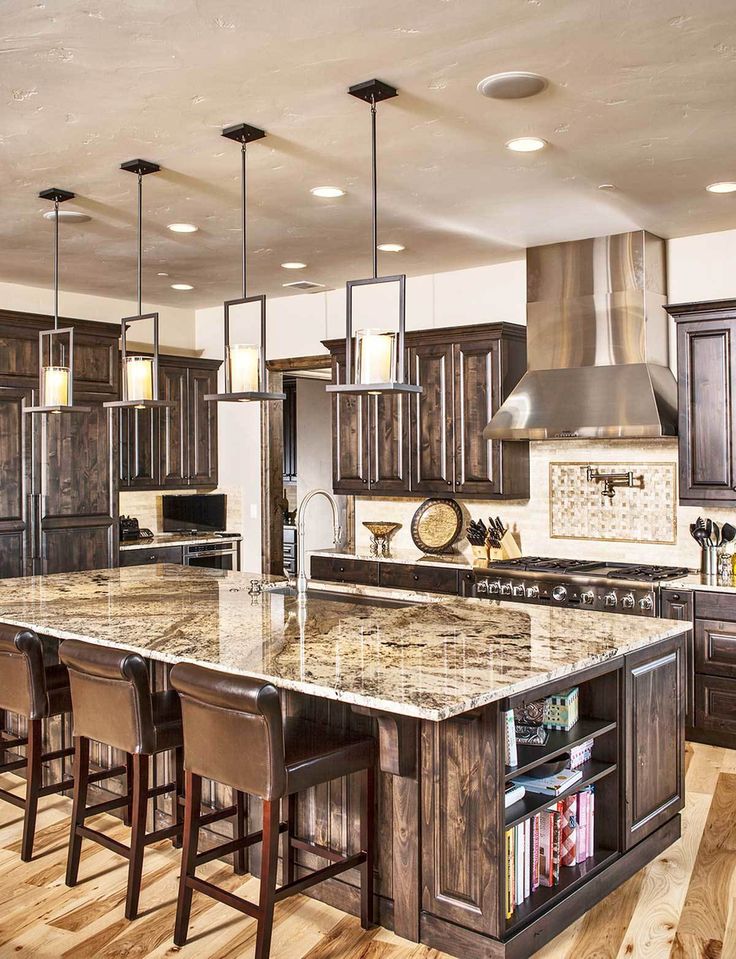 a large kitchen with an island in the middle and lots of counter space on one side