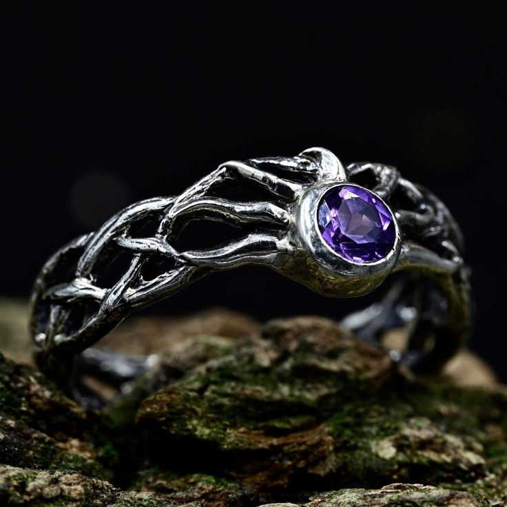 Crafted from sterling silver, our Ethereal Fairy Witchy Wedding Band is a unique and enchanting piece that seamlessly blends fantasy and nature. With intricate details inspired by the magic of a woodland elven realm, this ethereal jewelry captures the essence of a fairy witchy wedding. Ideal for those seeking a unique nature-inspired gift or a dark fairy ring for men, this silver braided ring with twig leaves is a distinctive accessory that adds a touch of enchantment to any occasion.  Characteristics: Metal - Recycled solid sterling silver  Stone - Cubic Zirconia 5.0 mm Finish - Oxidized. View all silver fairy rings: https://www.etsy.com/shop/TinyShinyJewel?ref=seller-platform-mcnav&section_id=4432099 Care instructions: To care for the ring, avoid contact with water and chemicals such as Fairy Rings, Witchy Wedding, Elven Ring, Silver Braided Ring, Ethereal Fairy, Ethereal Jewelry, Forest Magic, Silver Fairy, Funky Rings