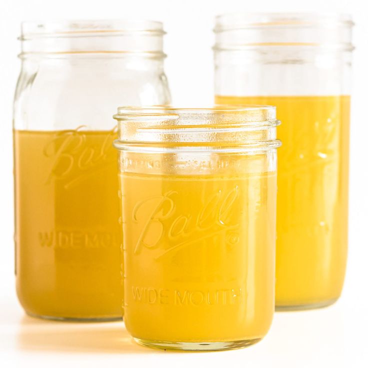 three mason jars filled with yellow liquid