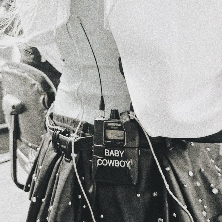 a black and white photo of a woman's back with an electronic device attached to her waist